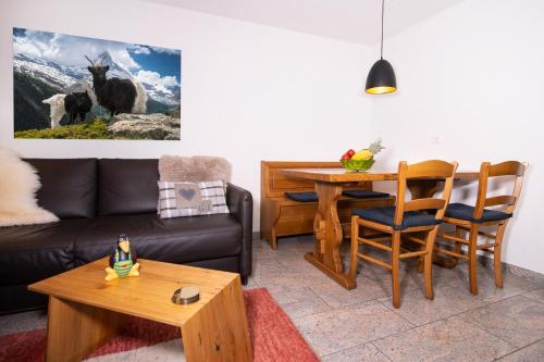 a living room with a couch and a table at Apartment Aura in Zermatt