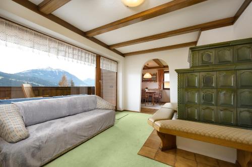 a living room with a couch and a large window at Zur Oma Margret in Flachau