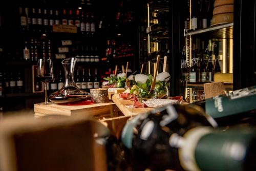 a bar with a counter with bottles of wine at Hotel Rovanada Wellness & BergNatur in Vals