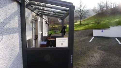 a door to a building with a sign in it at Ferienhaus Broche in Hilchenbach