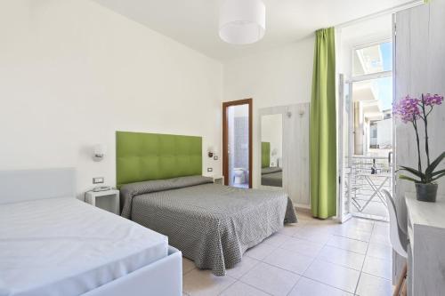 Krevet ili kreveti u jedinici u objektu Hotel Nuovo Tirreno