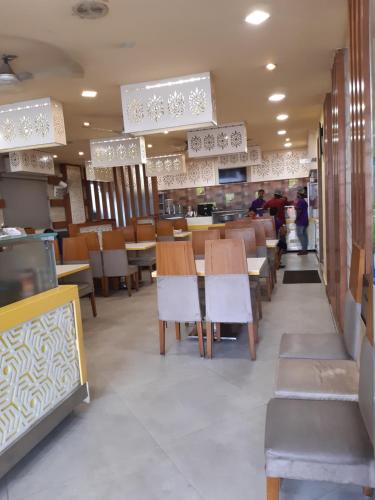 a restaurant with wooden tables and chairs and people at Empark in Bengaluru