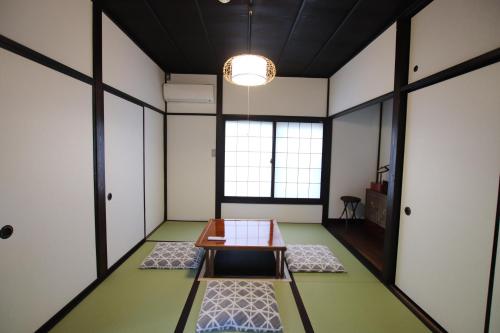 a room with a table in the middle of a room at Yamaguchi House Annex, Private House with Onsen in Hakone