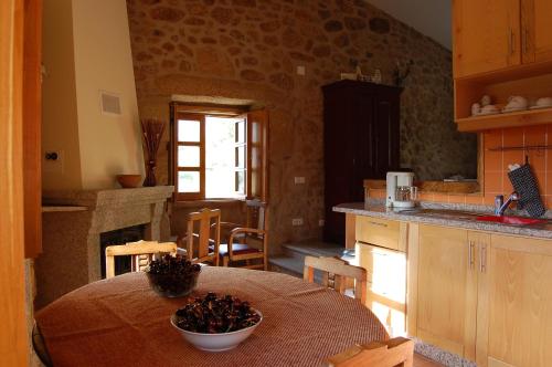 a kitchen with a table with a bowl of food on it at Casa da Carriça - Serra da Estrela in Guarda