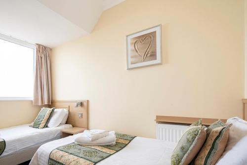 a hotel room with two beds and a window at Burbage Holiday Lodge Apartment 6 in Blackpool