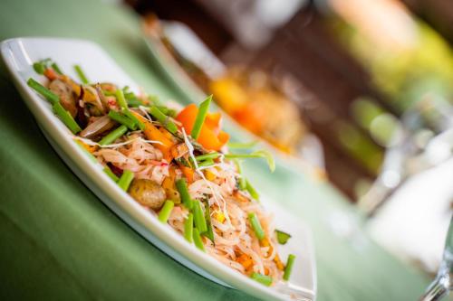 a plate of food on a green table at Coppenrath Hostel in Tangalle