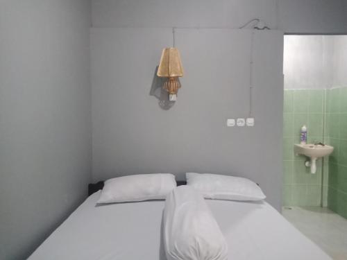 Un pat sau paturi într-o cameră la Tunas Rinjani Inn