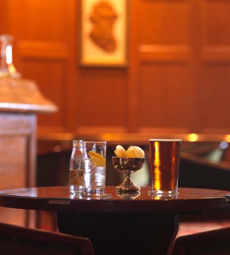 a table with two glasses and a bowl of food at North West Castle Hotel in Stranraer