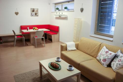 a living room with a couch and a table at Apartmán Resident A001 in Harrachov