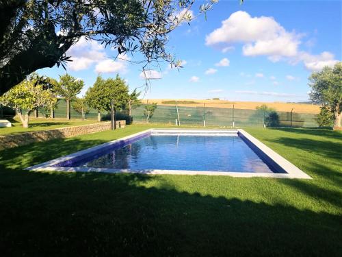 a swimming pool in the middle of a yard at Villa das Oliveiras in Sintra