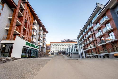 an empty street in a city with tall buildings at A Modern Suite Close to Gondola Ski Lift in Bakuriani