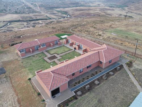 an overhead view of a house with a red roof at Twilight Breeze Lodge in Phuthaditjhaba