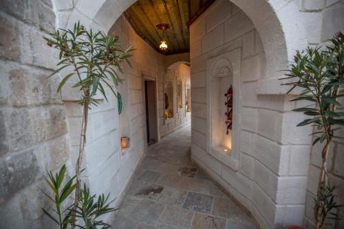 a hallway of a building with a stone wall at Zara Cave Hotel in Goreme
