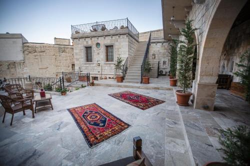 a courtyard with two rugs in front of a building at Zara Cave Hotel in Goreme