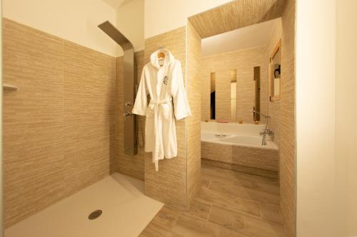 a bathroom with a white robe hanging on a wall at Artmonia in Castalla
