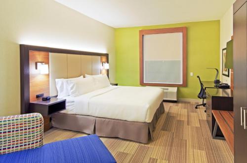 a hotel room with a large bed and a television at Holiday Inn Express & Suites - Phoenix North - Scottsdale by IHG in Phoenix