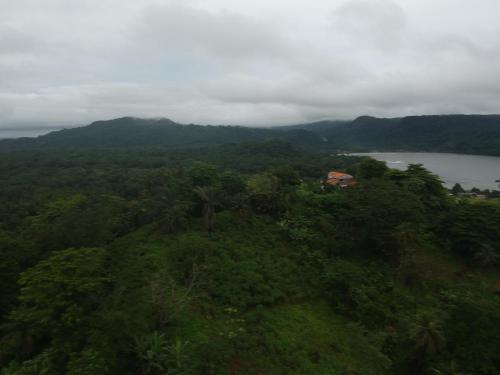 an aerial view of a hill with a house on it at N`Guembú Nature Resort in Porto Alegre