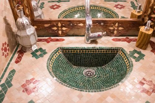 a bathroom with a sink with a faucet at Riad Ouarzazate in Ouarzazate