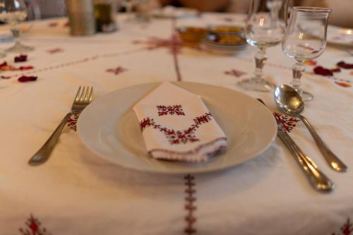 a plate with a napkin on top of a table at Riad Ouarzazate in Ouarzazate