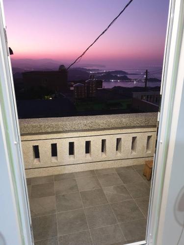 a view of the sunset from a balcony of a building at Jiufen Let's go Bed and Breakfast in Jiufen