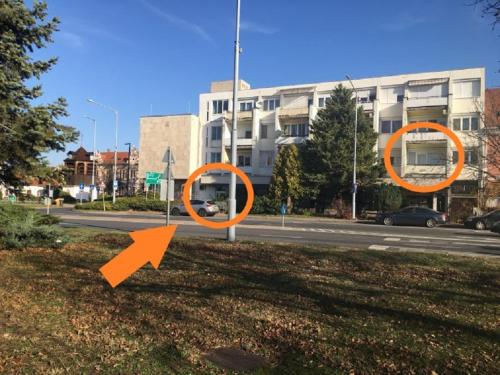 two orange signs on the side of a road at Harangláb Apartman Tata in Tata