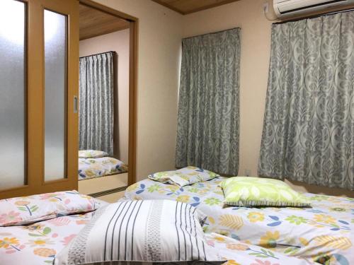 Un ou plusieurs lits dans un hébergement de l'établissement 大阪西九条stay