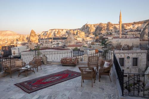 a balcony with chairs and a view of a city at Zara Cave Hotel in Goreme
