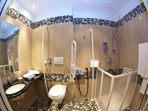 a bathroom with a shower and a toilet and a sink at Mitico Hotel & Natural Spa in Bologna