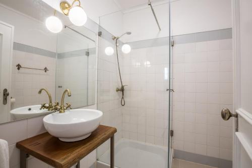 a bathroom with a sink and a shower at Sandhi House - Yoga & Wellness in Ericeira