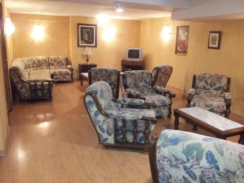 a living room with chairs and a couch and a table at Begoña Playa in Gijón