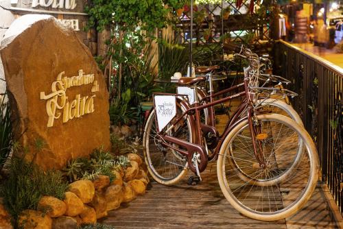 a bike parked next to a sign in a store at Hotel Giardino Di Pietra in Gramado