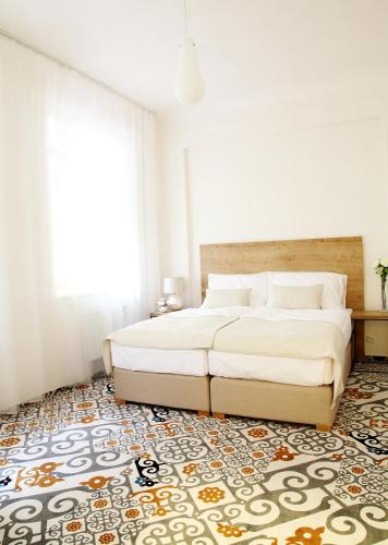 a bedroom with a large bed and a rug at Cett in Náměšť nad Oslavou