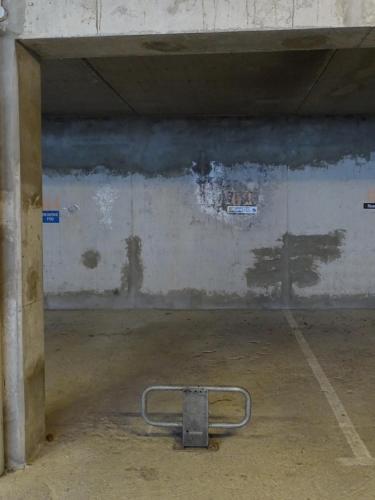 an empty parking garage with a metal rack in it at Studio avec jardin et garage, proche Super vénosc in Les Deux Alpes