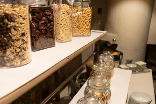 a row of jars of nuts on a shelf at Dorfmeister Business Hotel B&B in Weikersdorf am Steinfelde
