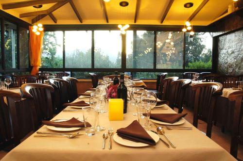 a dining room with a long table with wine glasses at Shavit Simple room in Arbel