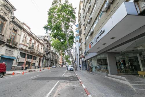 an empty street in a city with buildings at Urbano Hotel in Montevideo