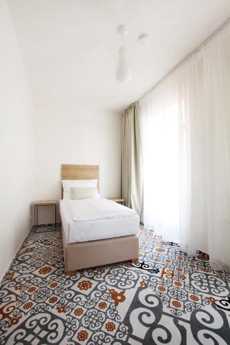 a bedroom with a bed and a rug at Cett in Náměšť nad Oslavou