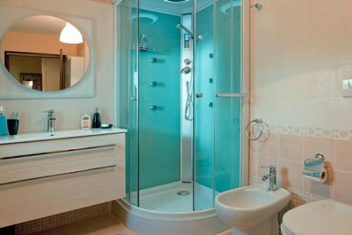 a bathroom with a shower and a toilet and a sink at ArcoSalento in Galatina
