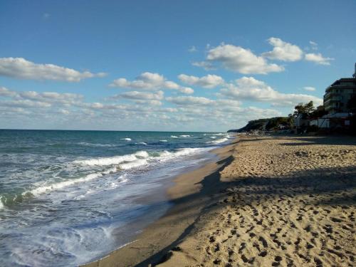 a beach with footprints in the sand and the ocean at Villa Sky Music in Obzor