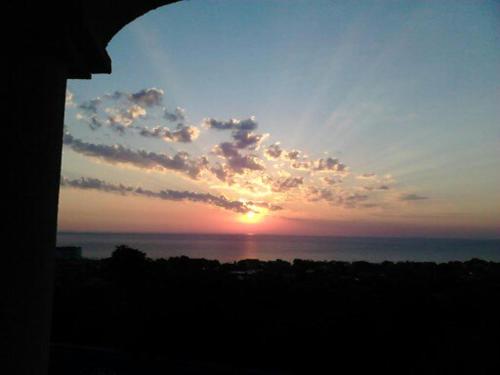 a sunset over the ocean with the sun in the sky at Villa Sky Music in Obzor