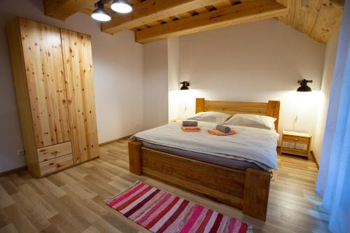 a bedroom with a bed with two shoes on it at Penzión Natália in Terchová