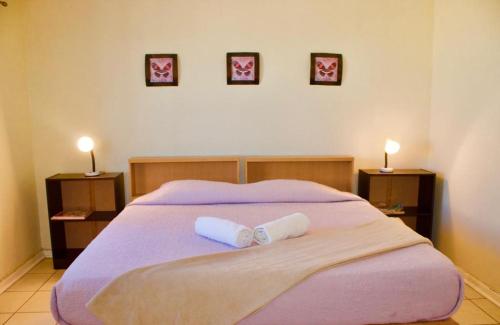 a bedroom with a bed with two towels on it at Emfuleni Country House in Butterworth