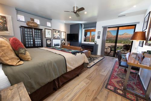 a bedroom with a bed and a living room with a table at A Sunset Chateau in Sedona