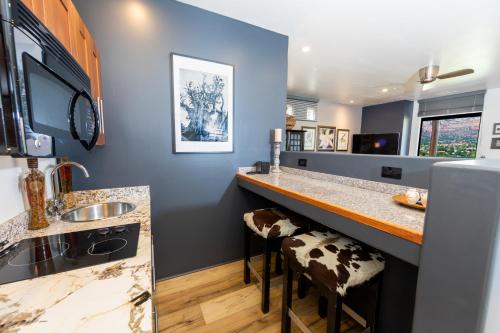 a kitchen with a counter with a sink and a bar at A Sunset Chateau in Sedona