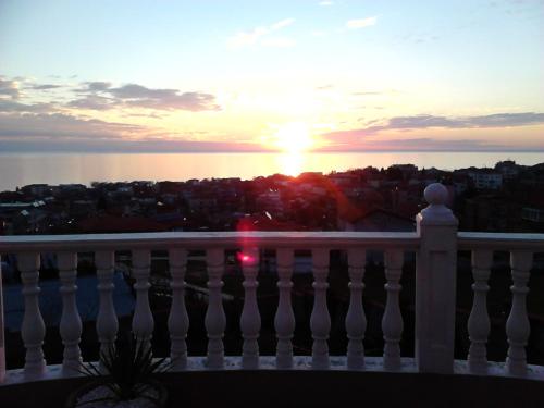 a sunset from the balcony of a building at Villa Sky Music in Obzor