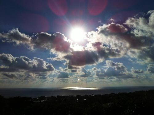 a view of the sun in a cloudy sky over the ocean at Villa Sky Music in Obzor