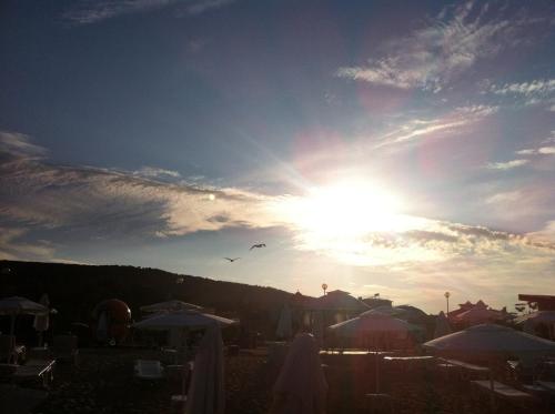 a sunset with kites flying in the sky at Villa Sky Music in Obzor