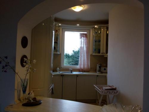 a kitchen with a sink and a window at Villa Sky Music in Obzor