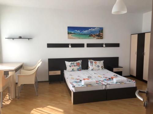 a bedroom with a bed and a table and a desk at Villa St Anna in Sozopol