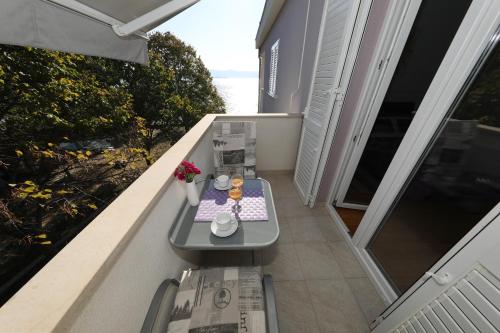 a balcony with a table with food on it at Lavanda Apartments in Sveti Petar